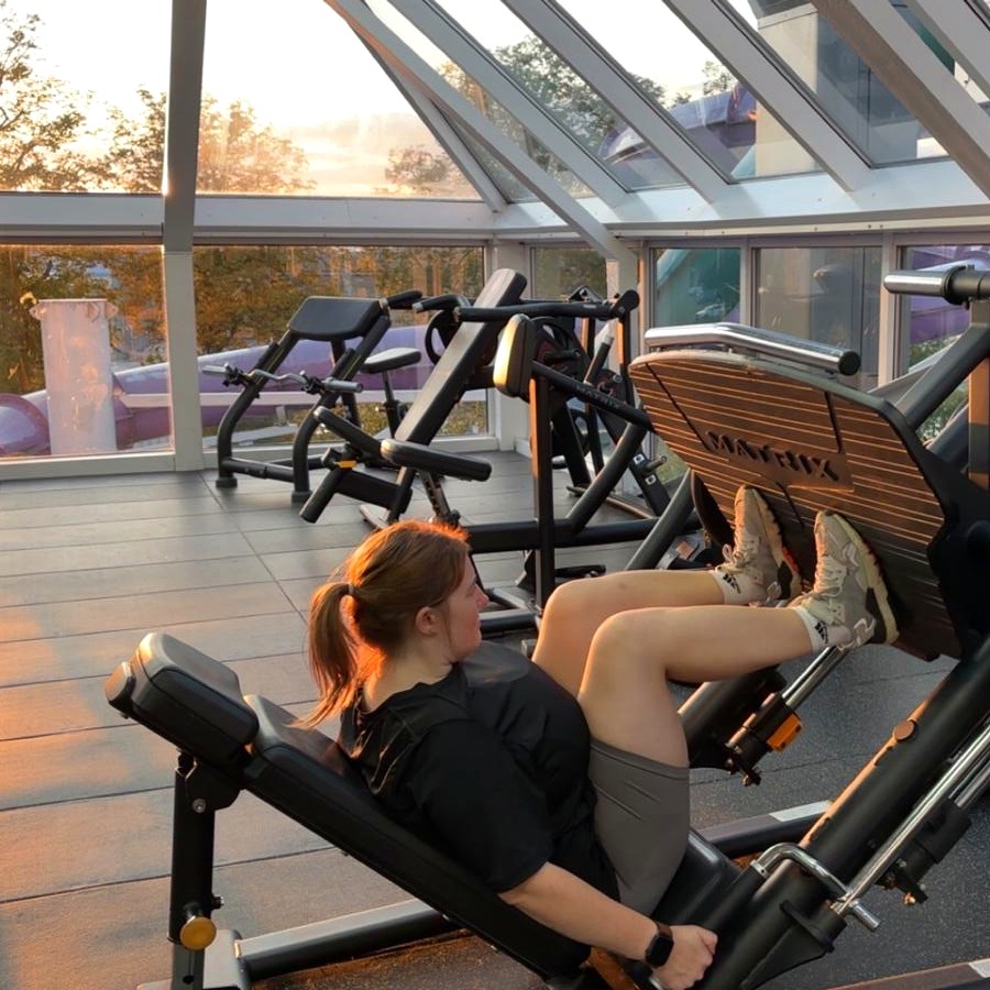 Training on a leg press in a gym
