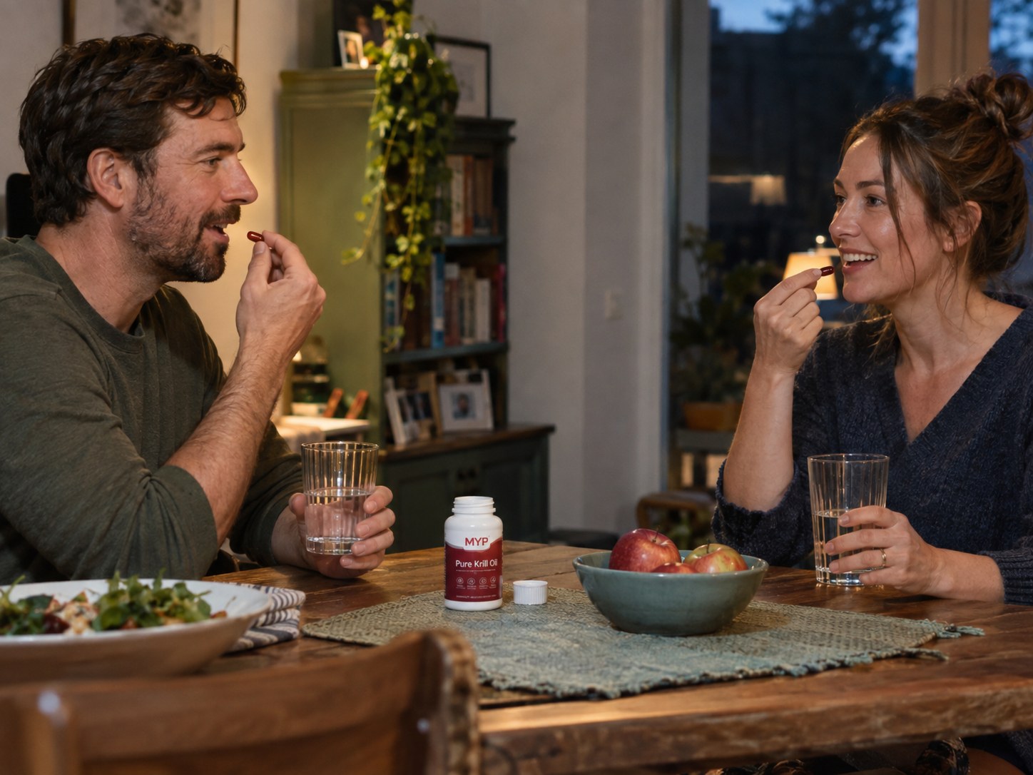 Couple taking their Pure Krill Oil capsules at a dining table at home